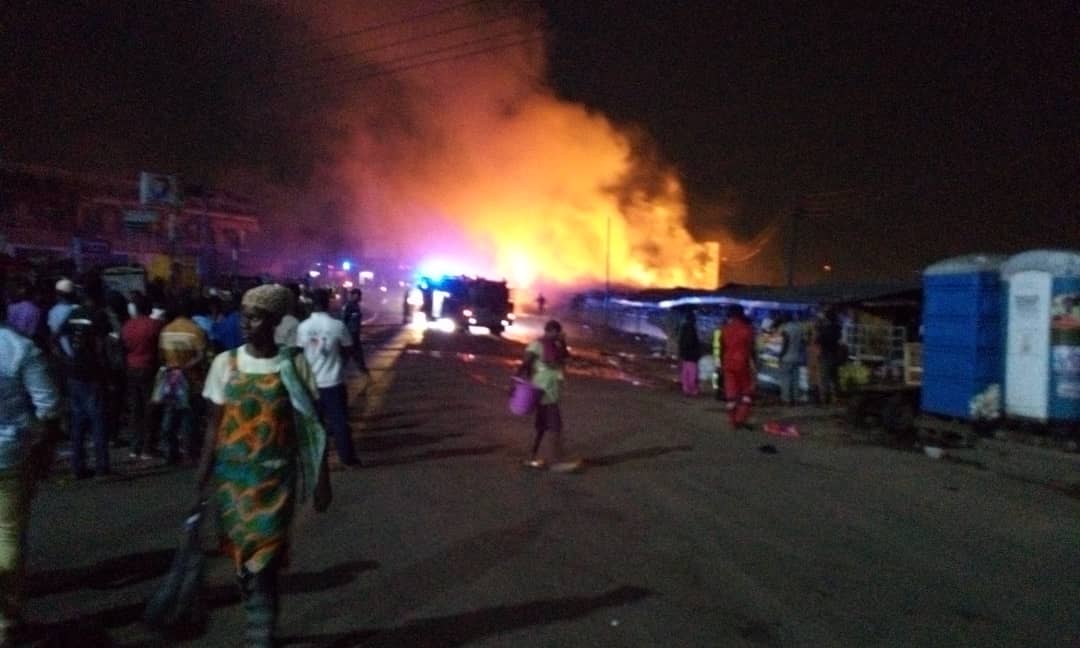 People gathered as a market burns