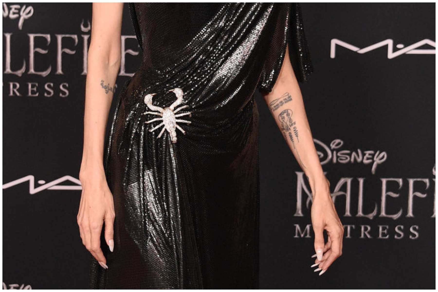 Angelina Jolie's Buddhist Swirl tattoo is seen as she arrives at the World Premiere Of Disney's "Maleficent: Mistress Of Evil" in Los Angeles, California.