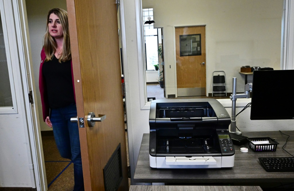 Election Registrar Joanna Francescut shows the new machines designed to count votes in Shasta County, California, on February 23, 2024