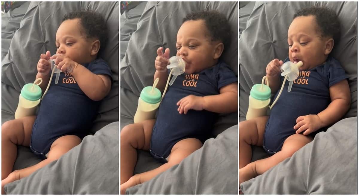 Photos of a little baby boy feeding himself with milk.