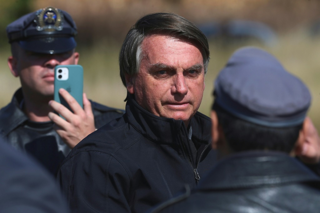 Brazil's President Jair Bolsonaro, seen here in May 2022, was caught on video grabbing a heckler by the shirt