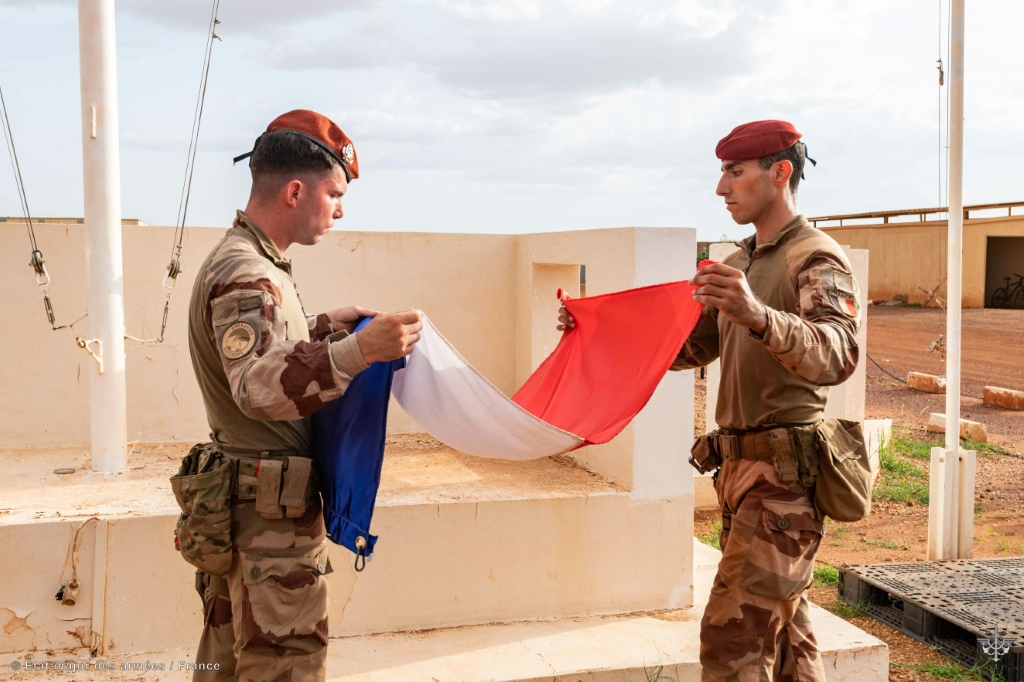 French soldiers folding up their flag as they left Mali in August