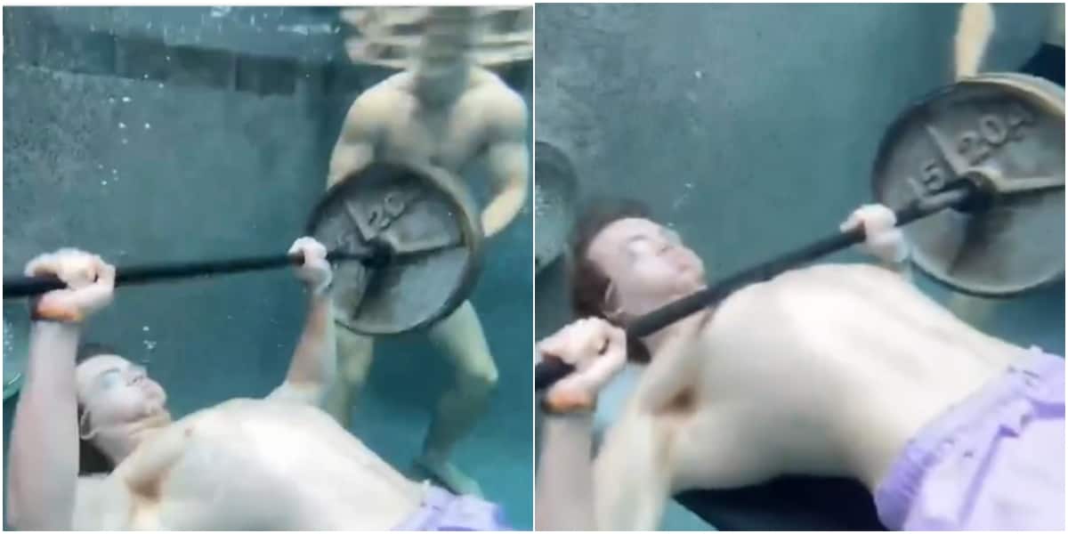 Young man displays weightlifting skills under water