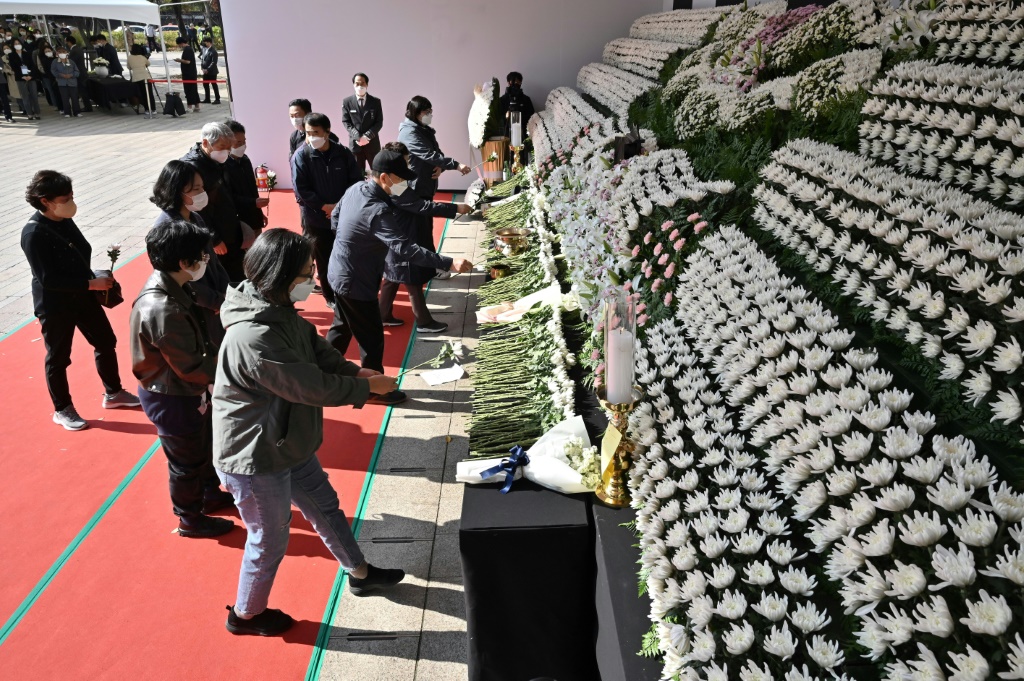 Mourners pay tribute in front of a joint memorial altar for victims of the deadly Halloween crowd surge in Seoul