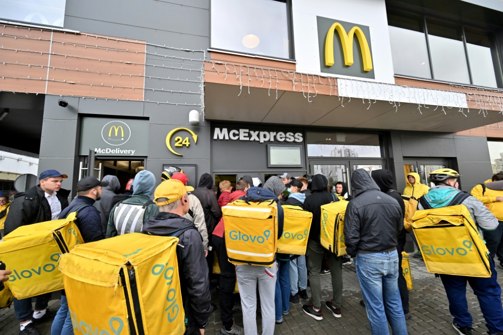 Delivery workers gather at a McDonald restaurant to pick up orders in Kyiv