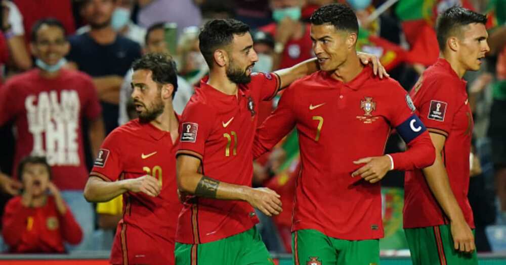 Bruno Fernandes of Portugal celebrates with teammate Cristiano Ronaldo after scoring a goal during the 2022 FIFA World Cup Qualifier match between Portugal and Luxembourg at Estadio Algarve on October 12, 2021 in Loule, Portugal. (Photo by Gualter Fatia)