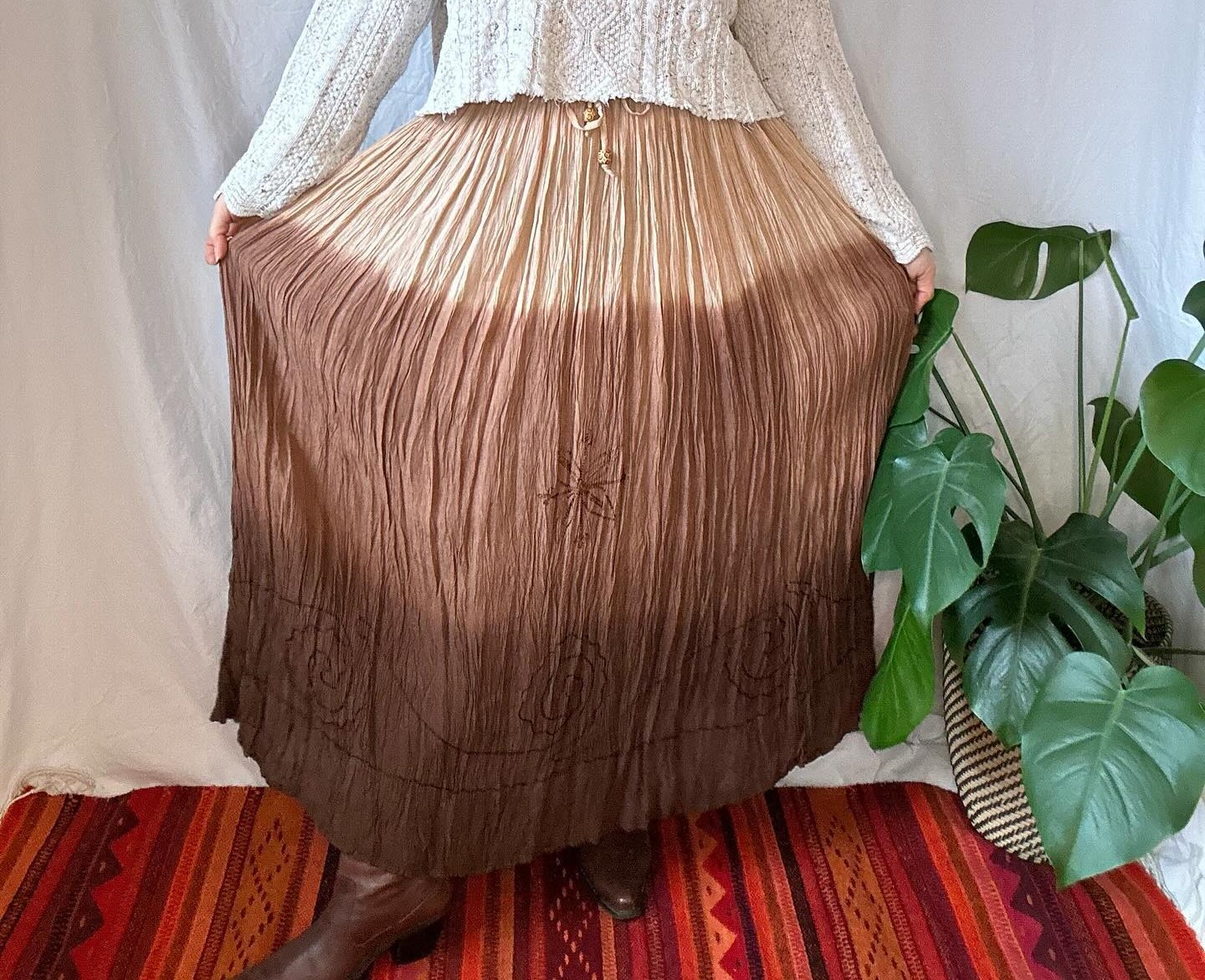A woman shows off her brown broomstick skirt
