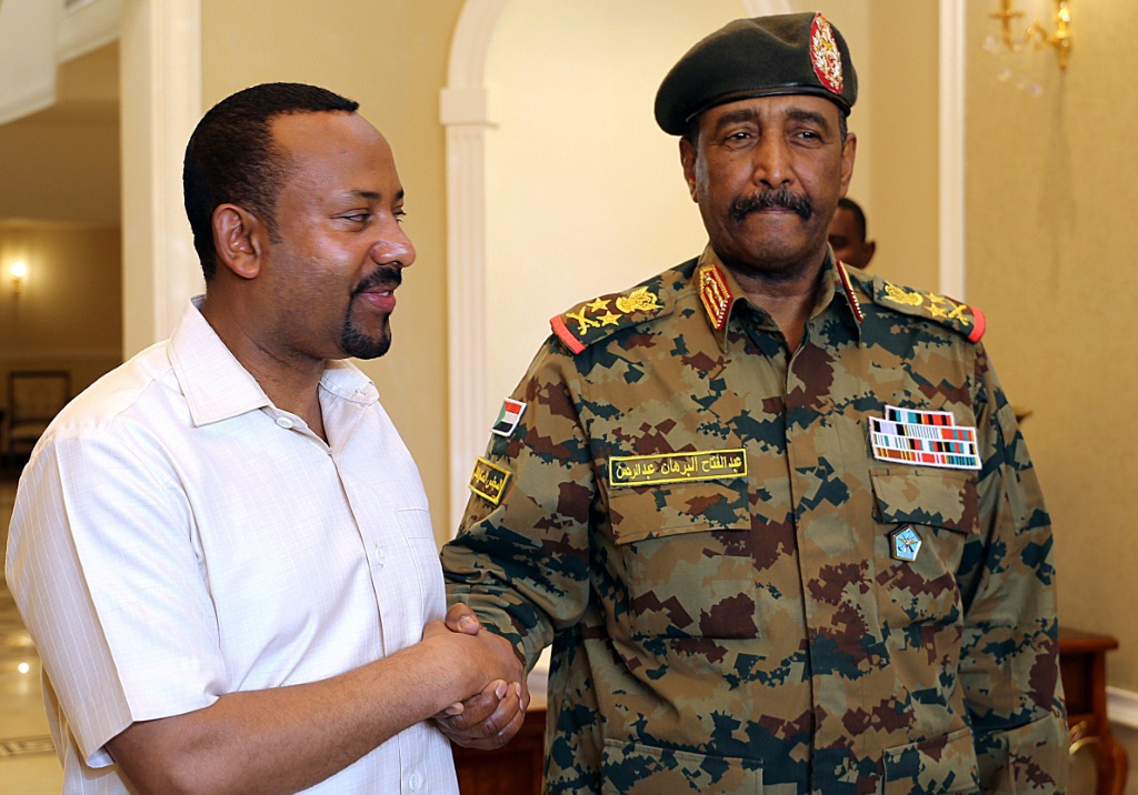Ethiopian Prime Minister Abiy Ahmed (left) is pictured with Sudan's military leader Abdel Fattah al-Burhan in Khartoum in 2019
