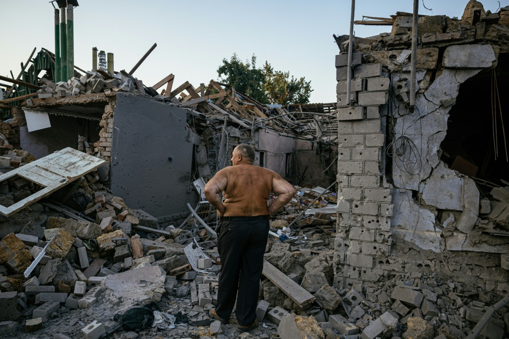 Oleksandr Shulga looks at his destroyed house following a missile strike in Mykolaiv