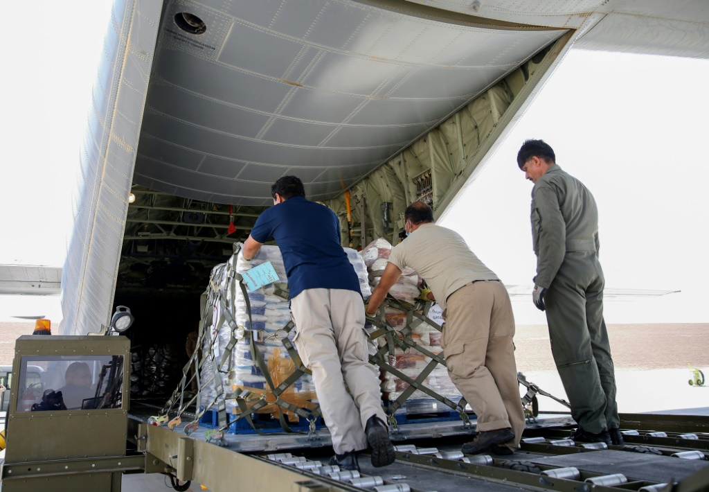Relief supplies are loaded onto an aircraft at Al-Udeid airbase in Qatar for delivery to Afghanistan
