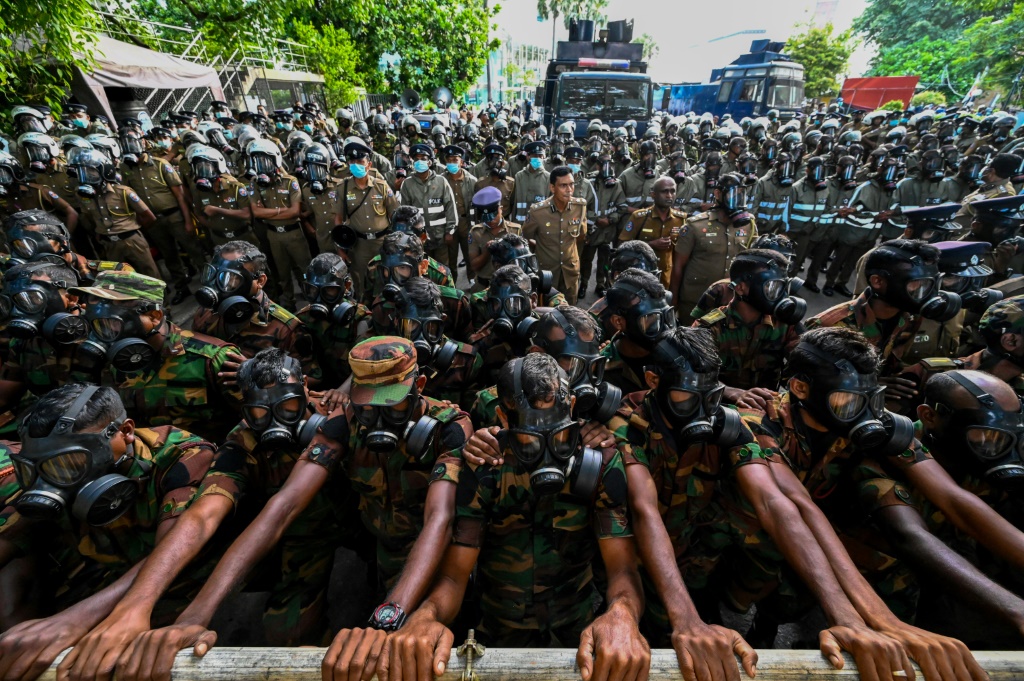 Soldiers stand guard behind barriers during anti-government protests demanding the resignation of Sri Lanka's President