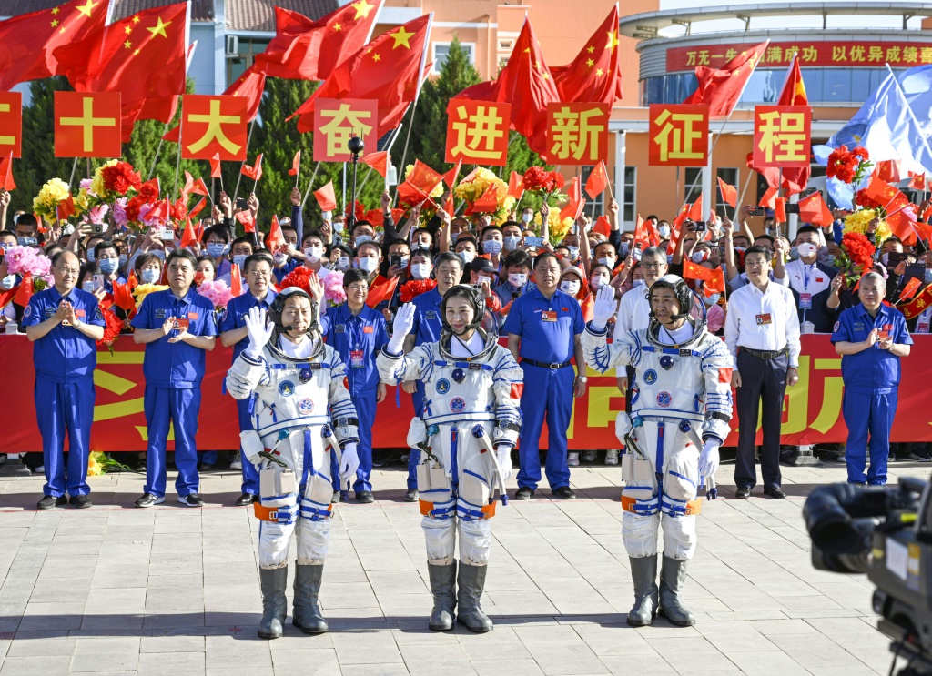 Chinese astronauts Cai Xuzhe (L), Chen Dong (C) and Liu Yang -- seen in June 2022 prior to their mission to the Tiangong space station -- have returned safely to Earth, state media reported
