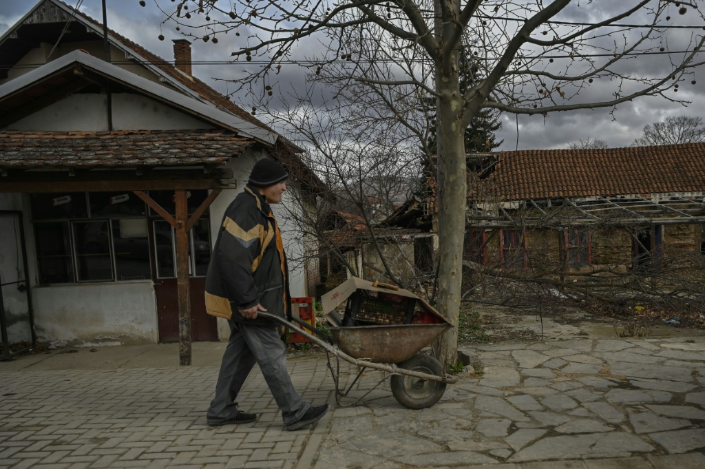 Stocking up: a Serbian man pushes a wheelbarrow through Gracanica, central Kosovo