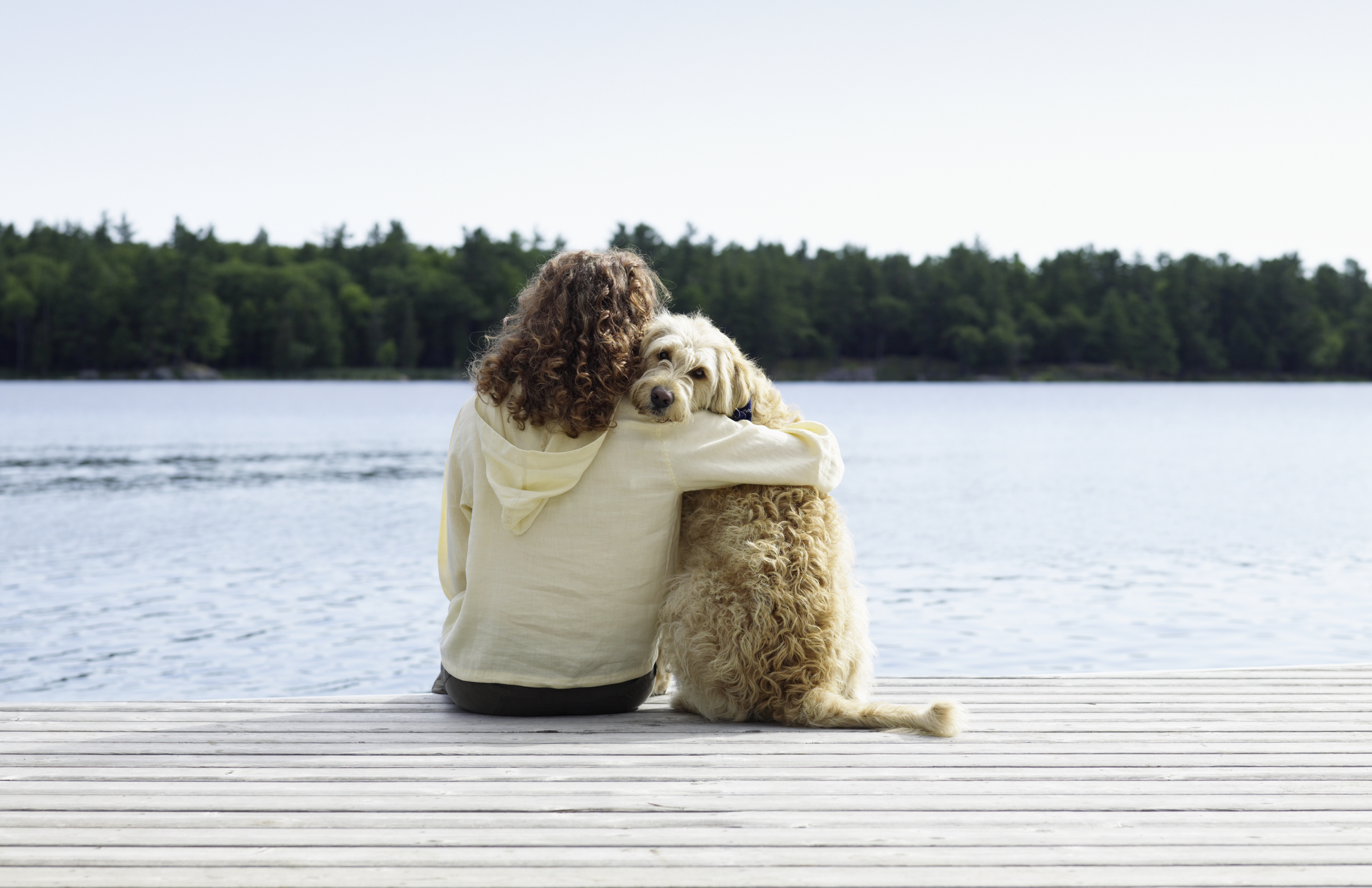 A woman and a dog in Stoney Lake, Ontario, Canada