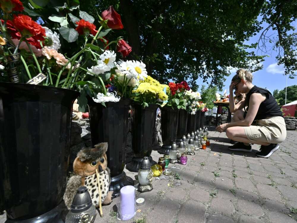 Local people laid flowers and left children's toys next to the burnt-out store