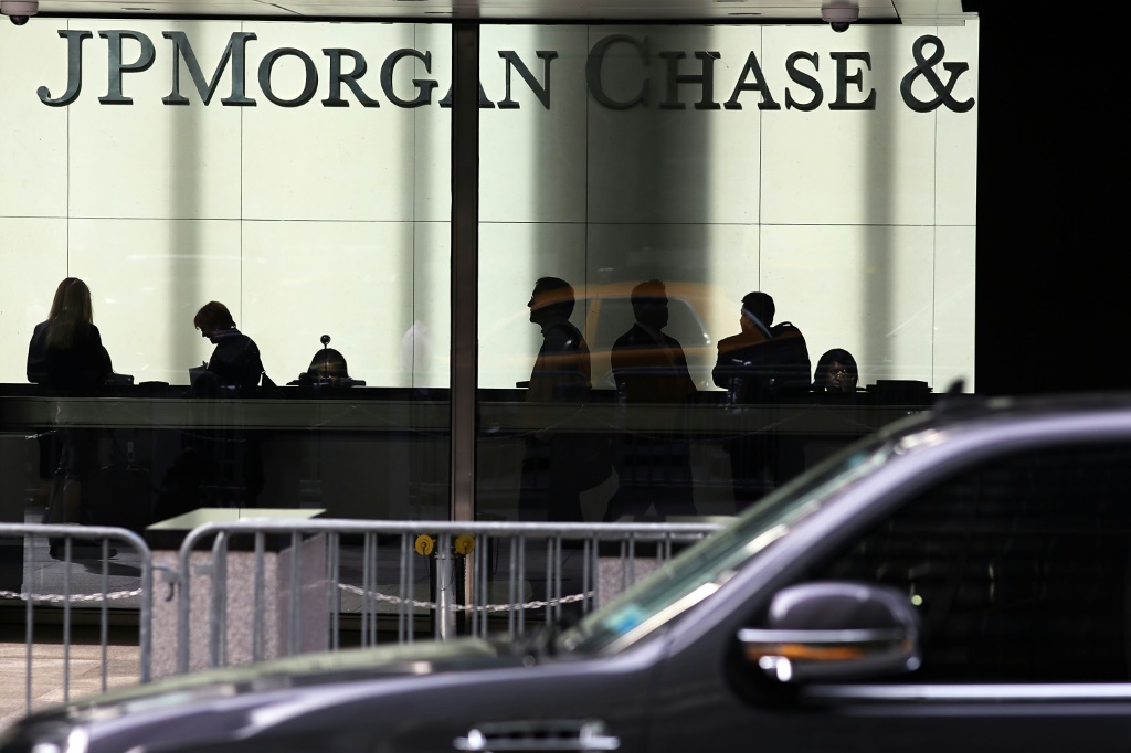 JPMorgan Chase reported lower quarterly profits as it set aside more funds in case of bad loans