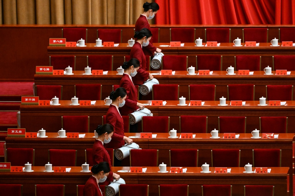 Attendants serve tea for the opening session of the Congress at Beijing's Great Hall of the People