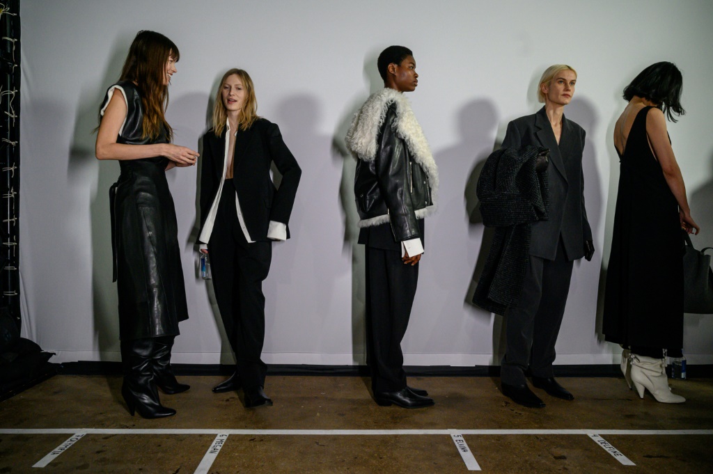 Models wearing clothing by Proenza Schouler gather backstage prior to their runway show during New York Fashion Week