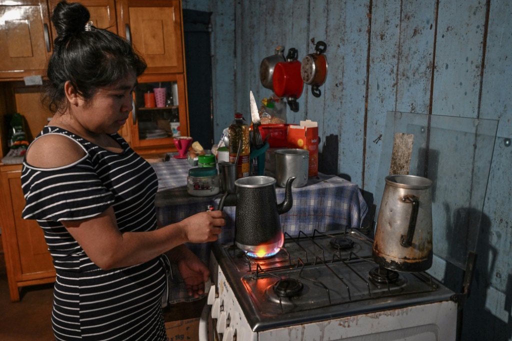 Daniela Acosta, one of the few Ava Guarani with a paying job, takes a bus every day at 2:30 am to work in a poultry processing plant -- but still struggles to buy food