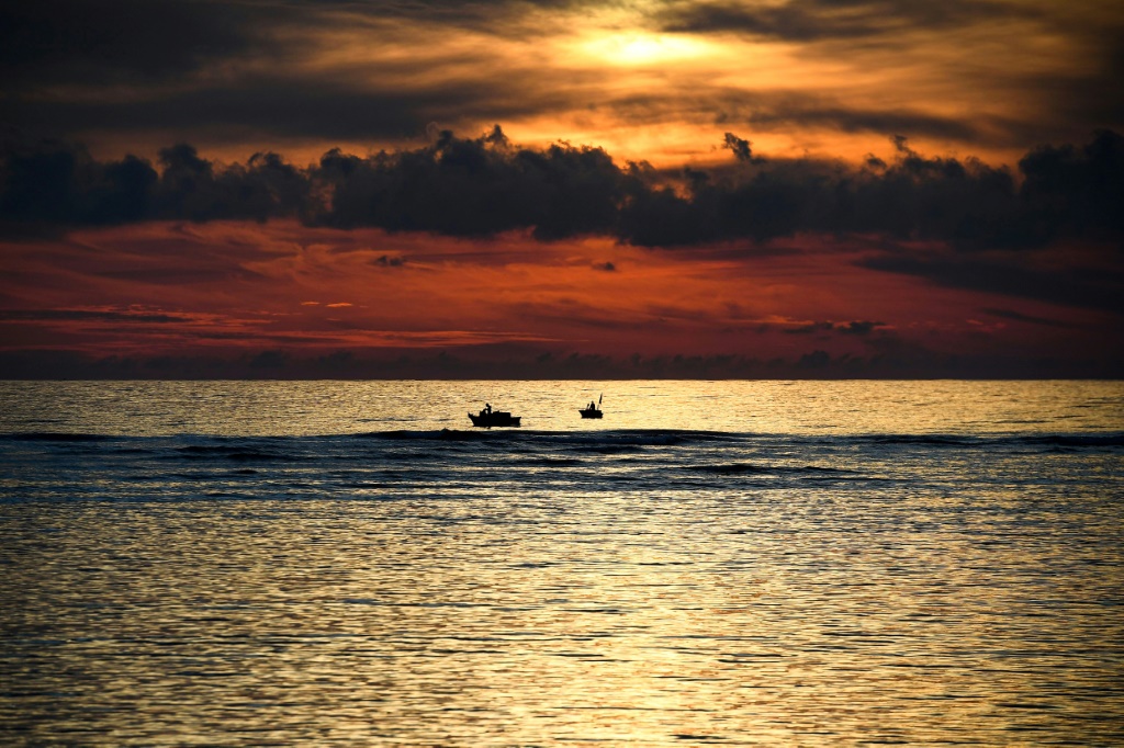 Fishing boats are seen at sunset near Ly Son island in central Vietnam