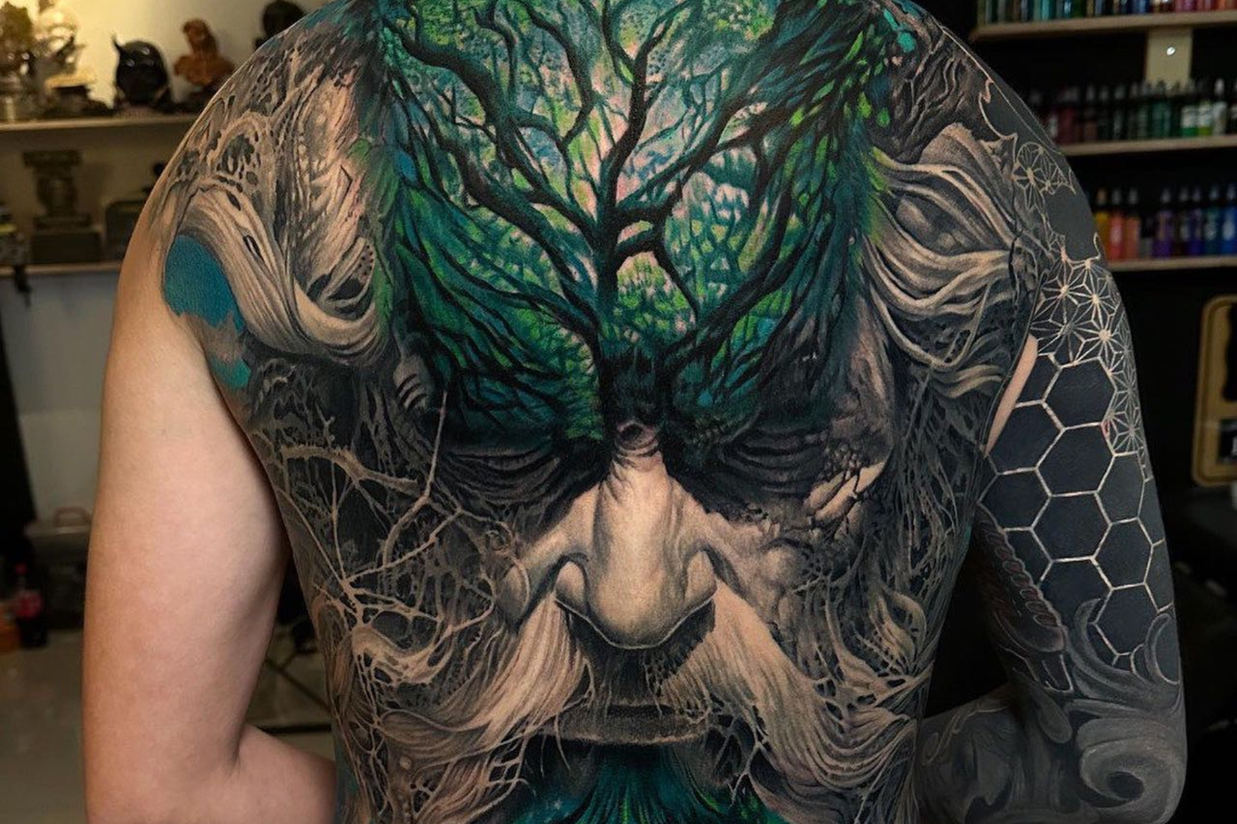 A man has a full back realism tattoo