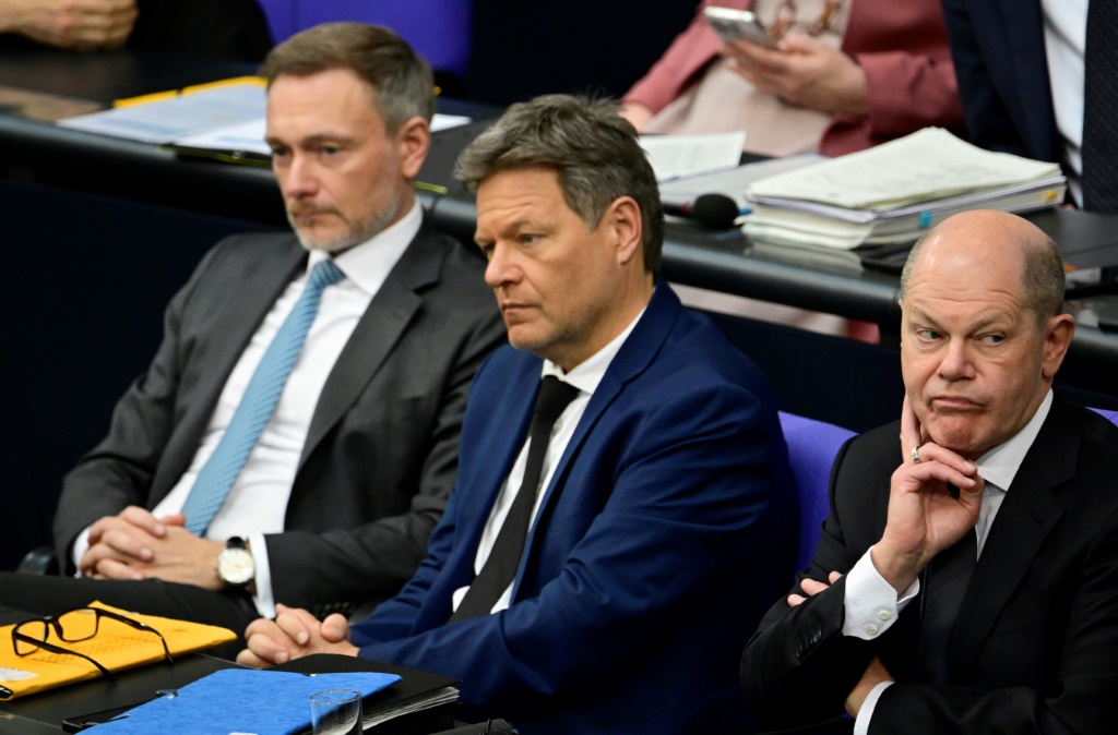 FDP Finance Minister Christian Lindner (L), Greens Economy Minister Robert Habeck (C) and Chancellor Olaf Scholz (R) of the SPD are locked in a budget dispute