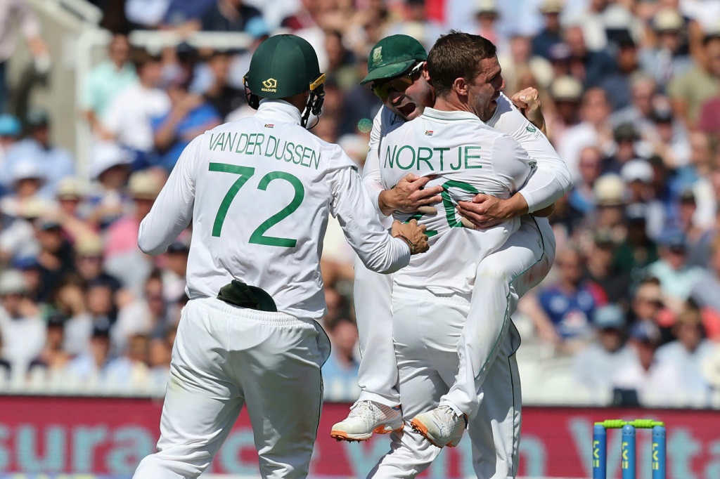 All together - South Africa's Anrich Nortje (R) celebrates with skipper Dean Elgar (C) after dismissing England's Alex Lees in the first Test at Lord's