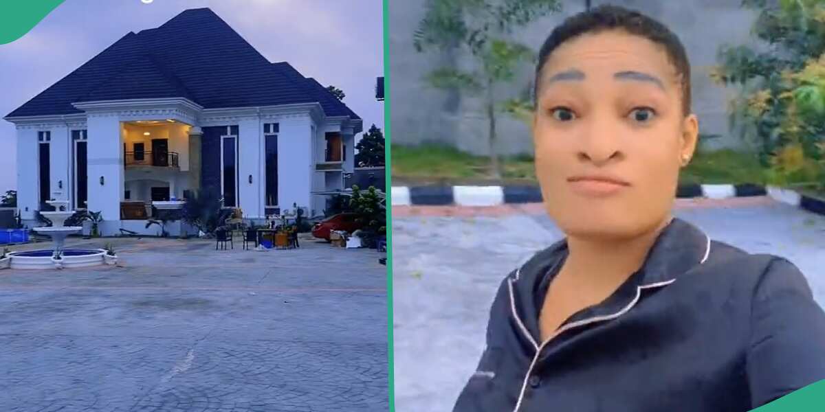 Lady shows off house in her village.