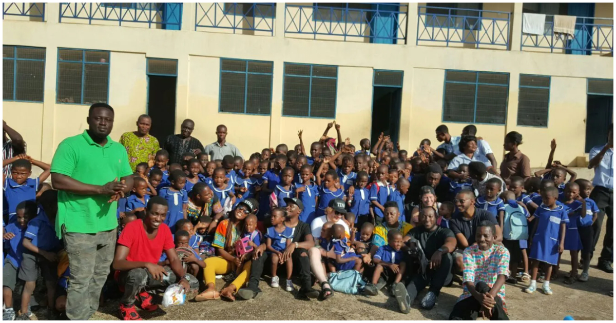 Fuse ODG poses with students at his orphanage school