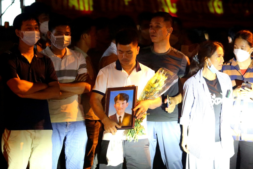 Family members of victims of a karaoke bar blaze in Vietnam that killed over 30 people waited outisde the morgue to identify their relatives