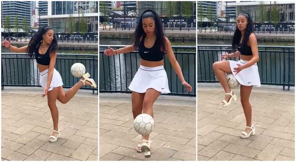 Photo of pretty lady playing football while dressed in Nike skirt.