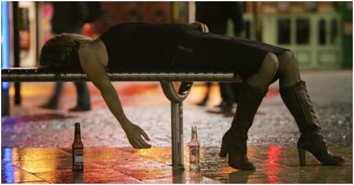 A woman lies on a bench after leaving a bar in Bristol City Centre on October 15, 2005 in Bristol, England