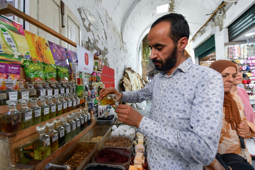 Tunisian perfumer Zouhaier Ben Abdallah blends jasmine extracts at his bazaar shop
