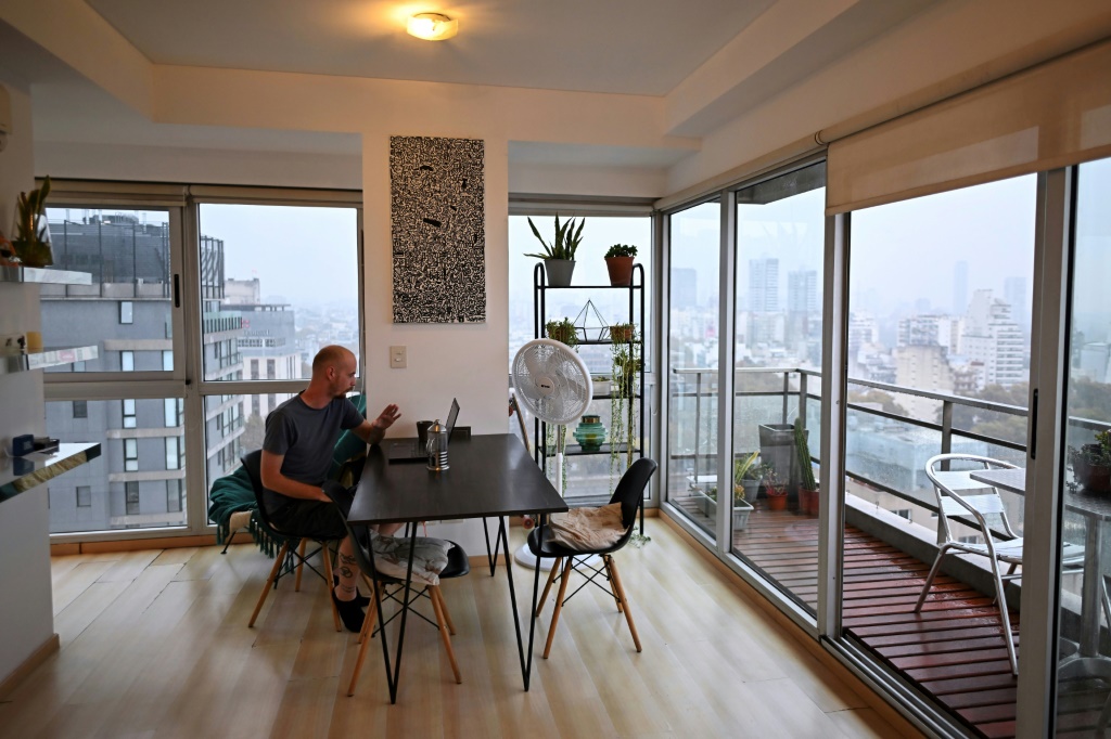 A Buenos Aires resident originally from New Zealand sits inside his rented modern apartment in the sought-after neighbourhood of Palermo