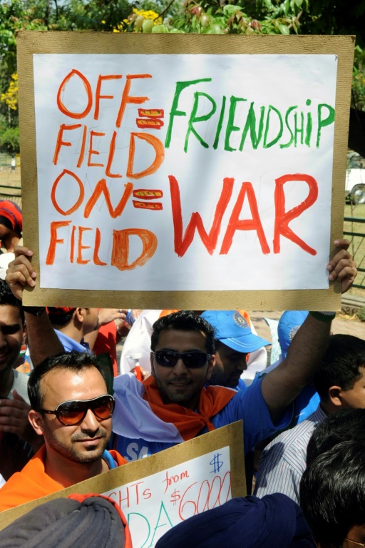 A fan holds up a placard summing up the cricket rivalry between India and Pakistan before the start of their World Cup semi-final match in Mohali in March 2011