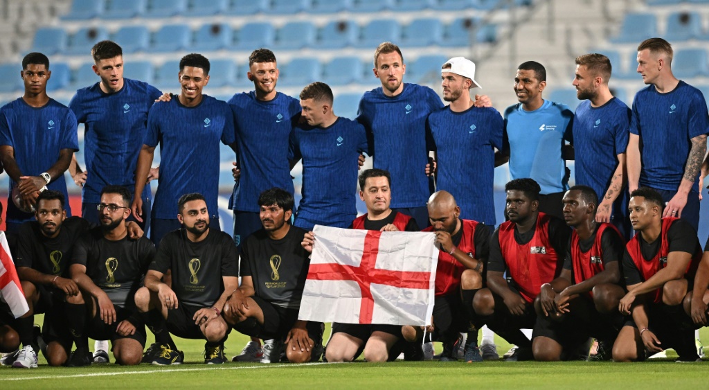 England's players pose with migrant workers at Al Wakrah Stadium in Doha ahead of the World Cup