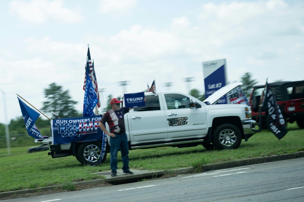 Supporters of former US president Donald Trump protest as US President Joe Biden's motorcade passes
