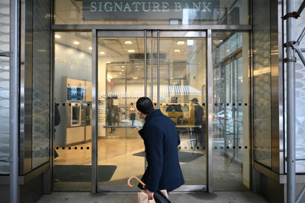 A man walks past a branch of Signature Bank in New York city on March 13, 2023