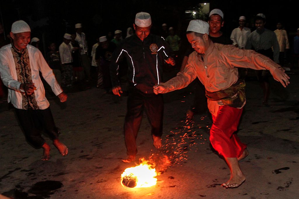 Indonesian Muslims playing soccer using a fireball in the commemoration of the Islamic New Year
