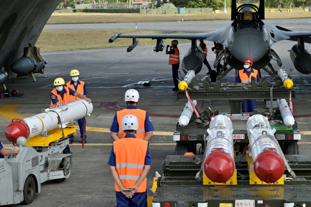 Taiwanese soldiers prepare to load US-made Harpoon anti-ship missiles in front of an F-16V fighter jet during a drill at Hualien Air Force base in August 2022