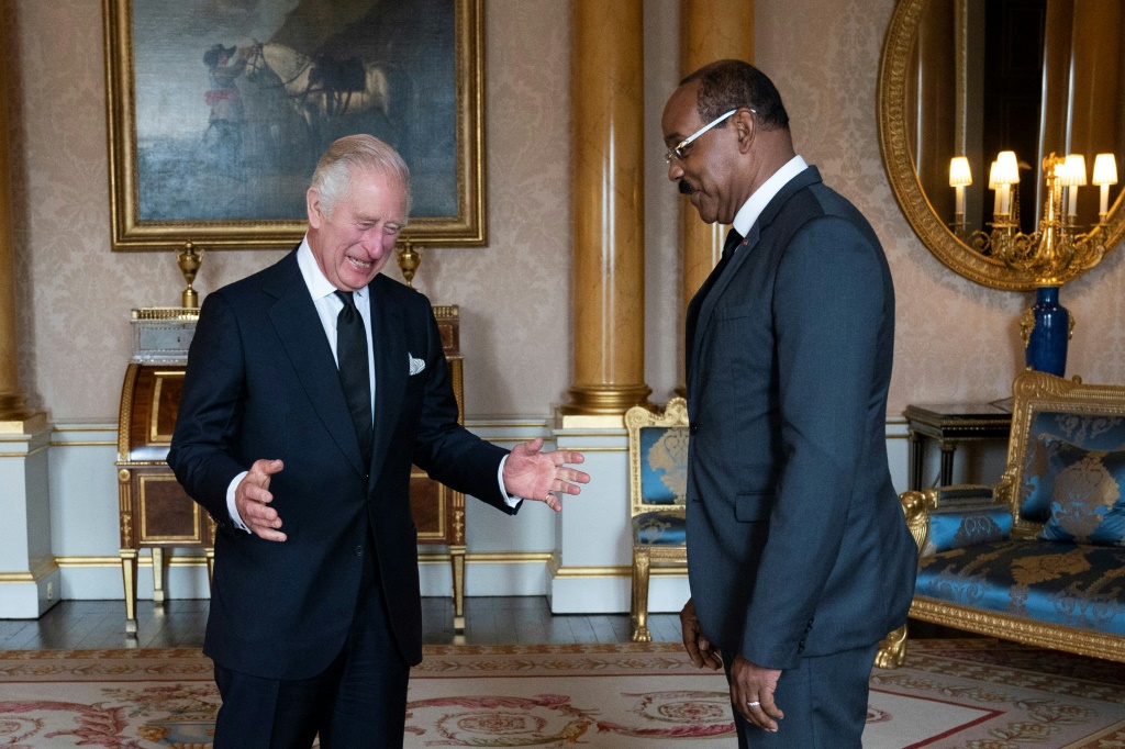 Britain's King Charles III (L) greets Prime Minister of Antigua and Barbuda Gaston Browne during an audience at Buckingham Palace on September 18, 2022