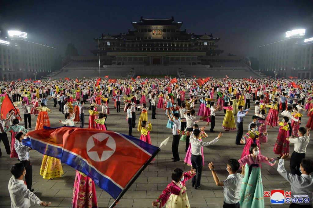 Young students celebrate the 69th anniversary of the Korean War at a night party in Pyongyang