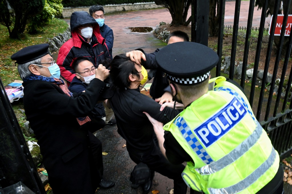 British police have said a group of men came out of China's Manchester consulate and dragged one of the protesters inside