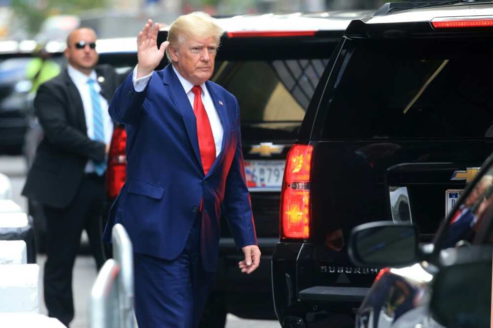 Former US president Donald Trump waves before attending a deposition in a New York civil case