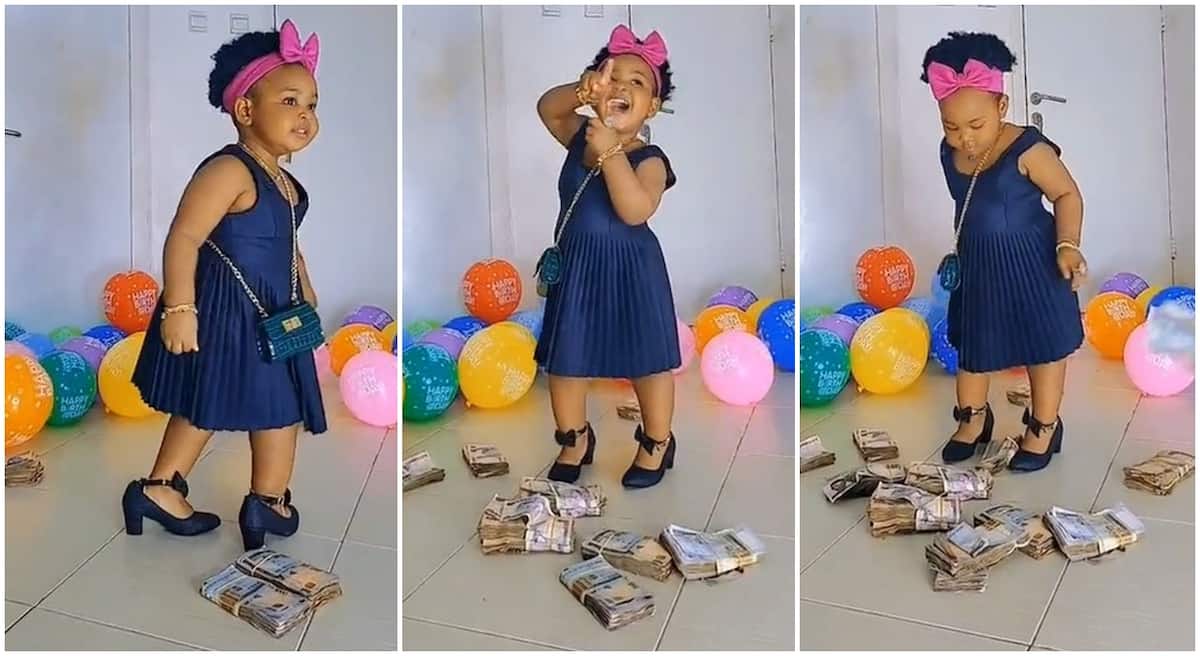 Photos of little Nigerian girl dancing as she is gifted bundles of cash.