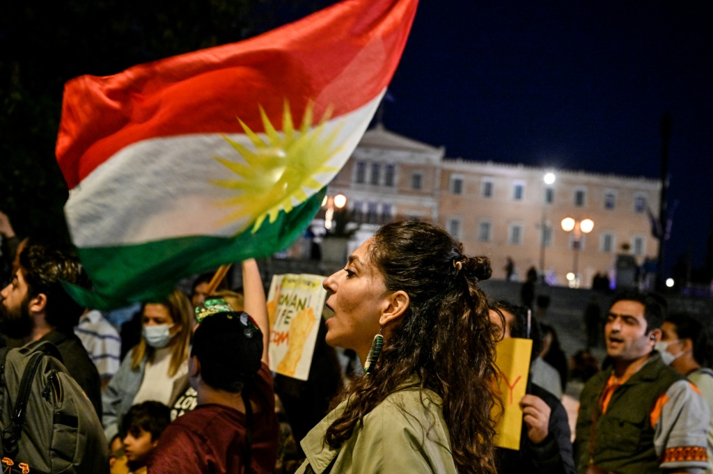 Iranians living in Greece wave a Kurdish flag while singing an Iranian protest song late last month -- one of many such protests worldwide in solidarity with those taking place in the Islamic republic