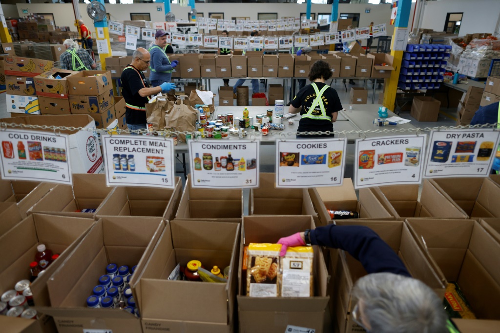 Volunteers sort through donated groceries at Daily Bread Food Bank in Toronto, Canada