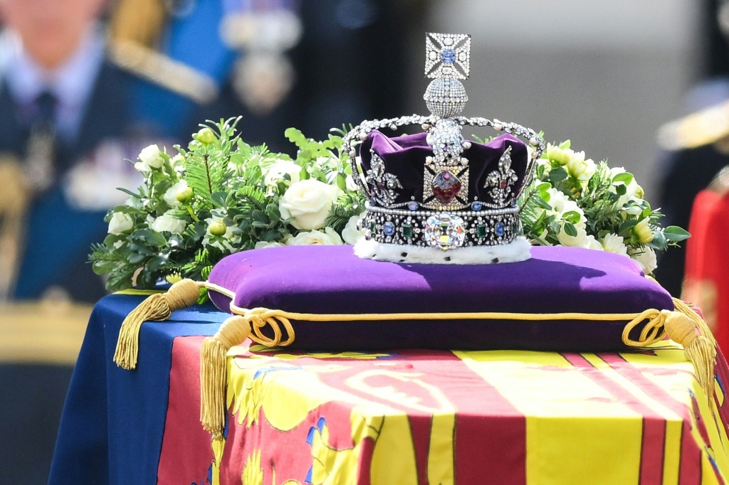 The Imperial State Crown has topped the heavy oak casket but will be removed before her burial at Windsor Castle