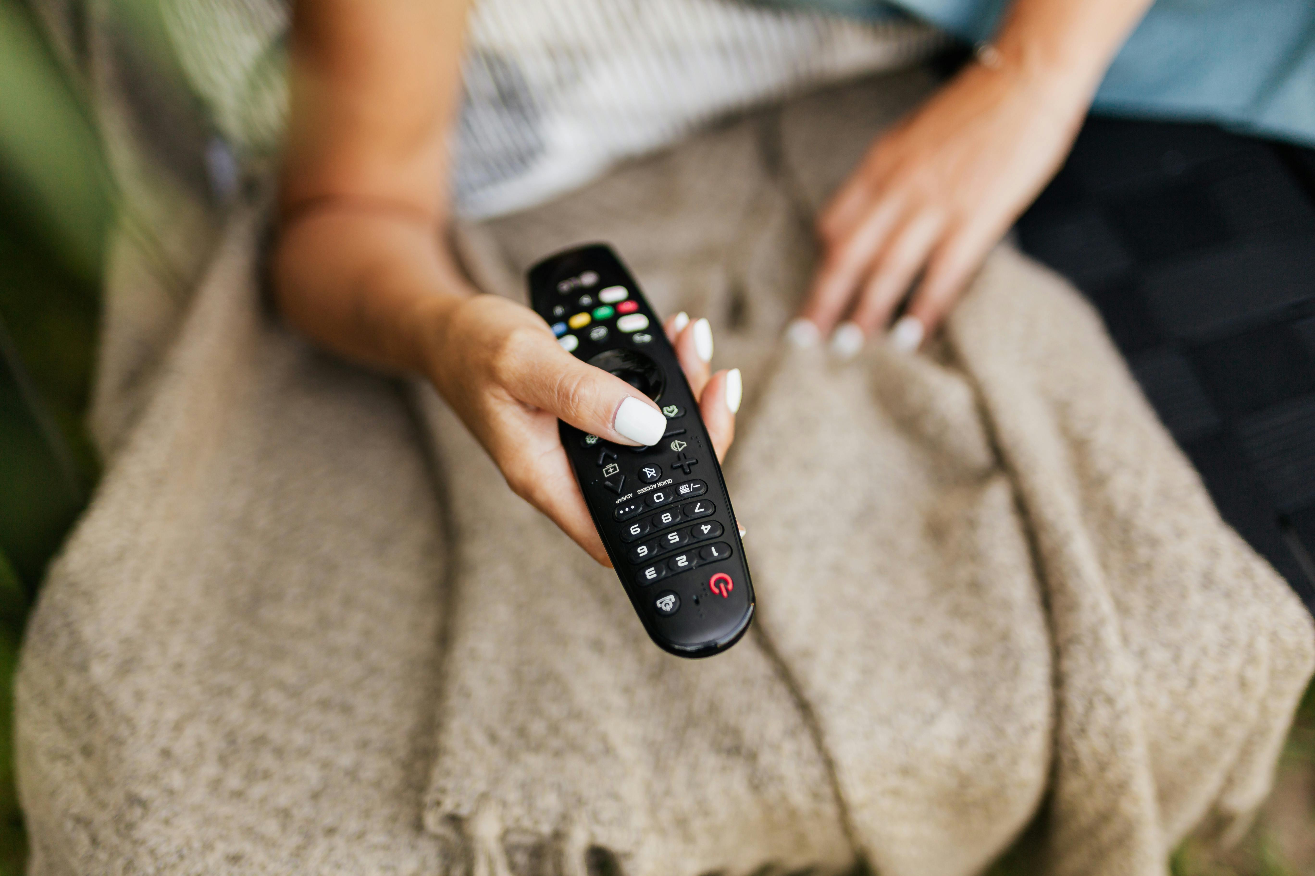 A person holding the remote control