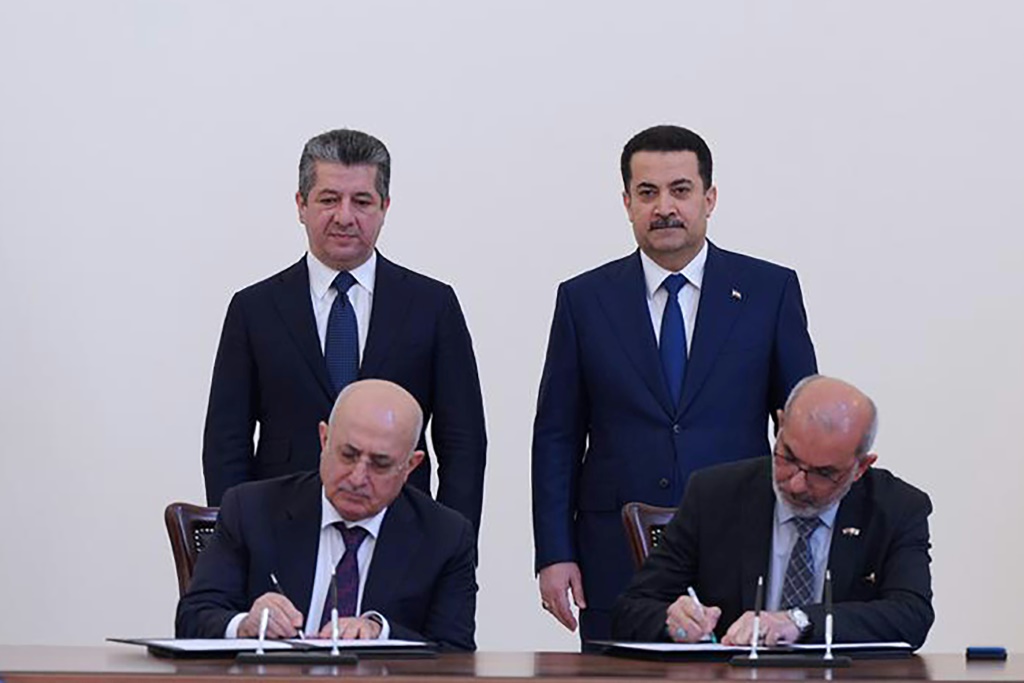 Iraqi Prime Minister Mohammed Shia al-Sudani, standing on the right, and his Kurdish counterpart Masrour Barzani attend the signing of the agreement